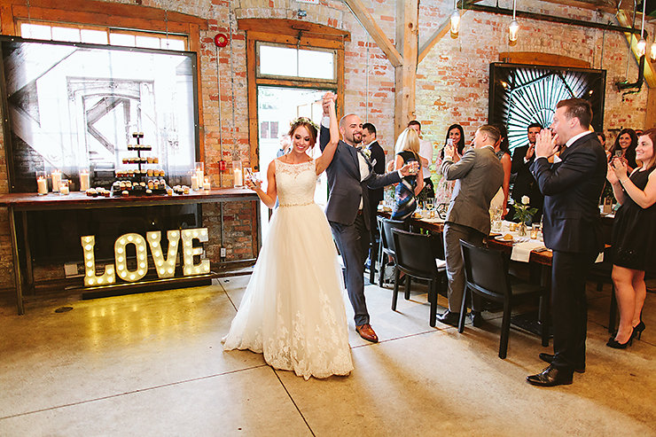 49-Bride-and-Groom-entrance-at-Archeo-Restaurant-Toronto-wedding-photographer.jpg